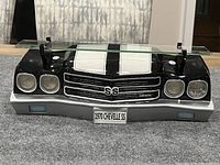 Front view of the 1970 Chevelle SS wall shelf showing detailed car front end replica with glass shelf on top.