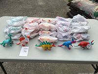 Overview of all dinosaur toys and wrapped pieces laid out on table