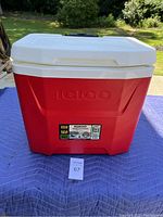 Front view of red and white Igloo cooler showing 28 quart size sticker and brand embossing