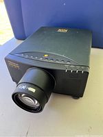Front-side angle of the black Proxima Desktop Projector 5600 showing control buttons and large lens.