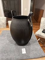Full view of large black textured rubber tub showing shape and size relative to surroundings.