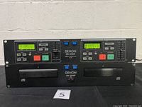 Front view of the Denon DN-2000F dual CD player unit with independent CD drives 1 and 2, power switch, and track display.