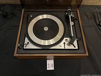 Top view photo of the Dual 1209 turntable without the dust cover, showing the platter, tonearm, and cartridge.