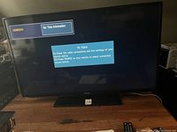 Front view of Samsung 46-inch TV powered on showing 'No Signal' message on screen.