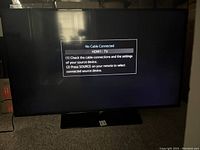 Front view showing powered on display with HDMI1: TV 'No Cable Connected' message