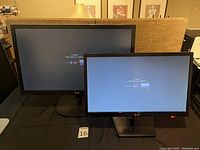 Front view of both LG monitors powered on, 22 inch and 27 inch sizes shown.