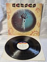 Front cover of Kansas 'Point of Know Return' album showing ship and glowing orb artwork with band and album name.