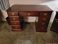 Front view of the solid wood classic desk showing the overall structure and surface condition.