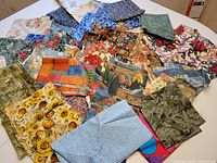 Top view of spread out assortment of various patterned fabric pieces highlighting diversity in designs and colors