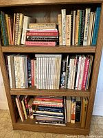 Front view showing full shelves filled with books and the wood grain texture.
