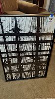 Front view of black and white framed artwork showing detailed ropes and rigging of a sailing ship.
