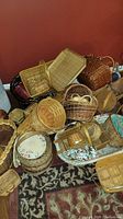Multiple photos of various baskets arranged on floor near red wall and carpet.