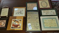 Overview of 11 framed artworks of various sizes and styles including illustrations, quotes, and decorative text.