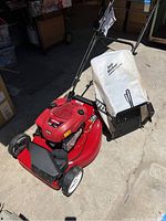 Full view of the Craftsman red lawn mower with rear white collection bag branded 'Dirt Picker'.
