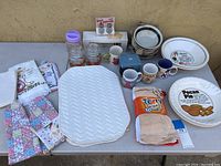 Wide view of entire kitchen collection on table showing all items