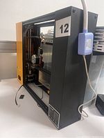 3D printer machine frame showing front and side profile with internal extruder and components
