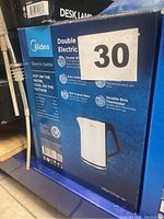 Box of Midea Electric Kettle showing model number MEK170W-VV and key features such as double wall insulation, auto switch off, 360-degree base, and durable thermostat.