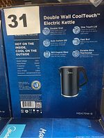 Photo of the original box for Midea Double Wall CoolTouch Electric Kettle showing features and specifications.