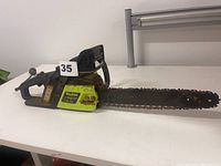 Full side view of the Poulan ES 350 chainsaw showing the entire chainsaw including the handle and guide bar with the chain.
