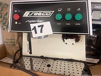 Close-up front view of the Saeco Superbar espresso machine control panel with buttons and red power button.