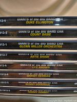 Photo of the spines of 8 CDs in the Giants of the Big Band Era collection featuring jazz big bands like Duke Ellington, Count Basie, Glenn Miller Orchestra, Artie Shaw, Les Brown, Woody Herman, Benny Goodman, and Tommy Dorsey.