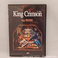 Front cover of King Crimson Deja VROOOM DVD case with artistic illustration and title.