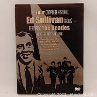 Front cover of The Four Complete Historic Ed Sullivan Shows Featuring The Beatles DVD showing sepia-tone portrait of Ed Sullivan and The Beatles with guitars.