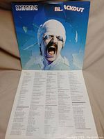 Front of the album cover featuring the 'Blackout' artwork with a screaming man with bandaged eyes and the band name and album title.