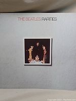 Front cover of 'The Beatles Rarities' vinyl album with band photo and title text on light gray background.