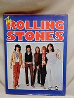 Cover photo of The Rolling Stones on the photo book's front, showing five band members standing in a line.