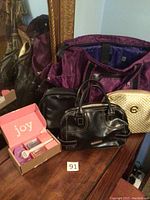 Four bags and one boxed new razor displayed on wooden surface next to mirror