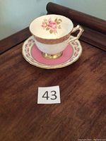 Cup and saucer displayed on a wooden surface, showing overall design and shape