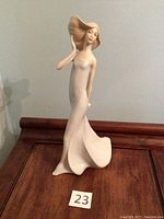 Front view of the Royal Doulton Reflections Windswept figurine showing flowing dress and hat details.