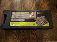 Closed case showing label with brand Marcy and image of dumbbells inside.