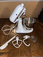 Another angle of the KitchenAid white stand mixer with mixing bowl and power cord.