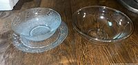 Photo showing a frosted glass serving bowl set on a matching frosted serving plate with leaf pattern, beside a clear Pyrex glass mixing bowl