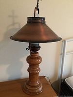 Full view of the vintage table lamp showing the copper shade and turned wooden base