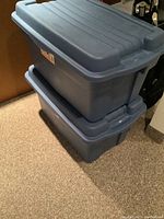 Two blue Rubbermaid Roughneck storage totes stacked, showing size and condition.