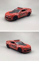 Two angled views of the red Kinsmart 2017 Chevrolet Camaro firefighter-themed die-cast model car showing detailed decals and roof light bar.