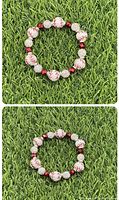 Baseball themed bead bracelet, laid flat on grass, showing bead arrangement and size