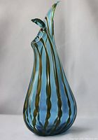 Front view of 7-inch tall, vintage Italian hand blown glass vase with multicolor twisted stripes and sculpted rim