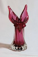 Murano glass vase with pink and red tones, flared top and clear base, shown from front