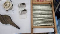 Overview of entire lot including bellows, clock, baby shoes, and washboard