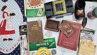 Overview of the collected vintage and decorative items in the lot, including the book 'The Crisis' by Winston Churchill, automatic card shuffler, quartz crystal, shorthand dictionary, wall hanging, and other small collectibles.
