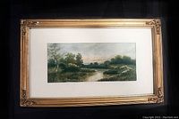 Full view of framed watercolour with mat and gilt carved wood frame against black backdrop
