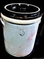 Front view of antique six gallon salt glaze crock with lid, showing the '6' marking and side handles.