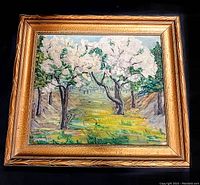 Full view of the framed oil painting showing blossoming trees and landscape