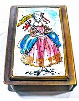 Close-up of the porcelain painted top of the match box holder showing the colorful depiction of a woman in a dress holding a yellow feather.