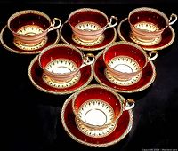 Photo showing all six Aynsley teacup and saucer sets arranged on black background, highlighting color and pattern details
