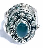 Front view of the vintage hinged silver ring showing oval jade color glass and detailed silver work.